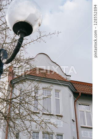 Historical architecture. modenrn. large building with a red roof and white trim. Historical architecture. modenrn. large building with a red roof and white trim. 128552894