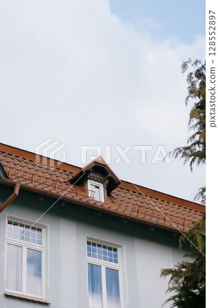 Historical architecture. modenrn. large building with a red roof and white trim.  128552897
