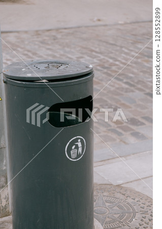 trash can marked Do not litter. green round container for waste collection.  128552899