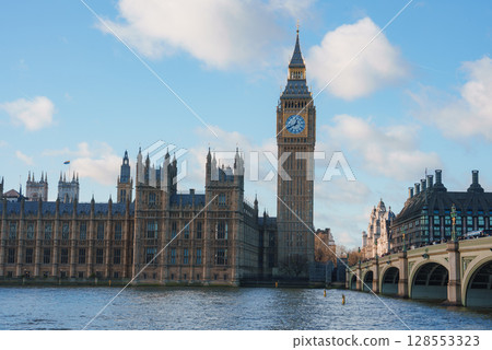 View of Big Ben and the Houses of Parliament in London, England, with the River Thames in the foreground and Westminster Bridge on the right. View of Big Ben and the Houses of Parliament in London, England, with the River Thames in the foreground and Westminster Bridge on the right. 128553323