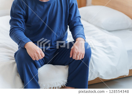 Men sitting on bed 128554348