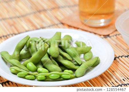 Delicious edamame beans on a plate and beer 128554467