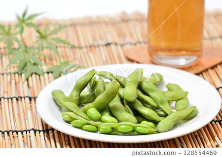 Delicious edamame beans on a plate and beer 128554469