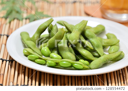 Delicious edamame beans on a plate and beer 128554472