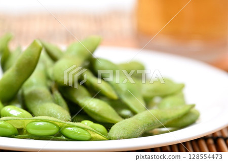 Delicious edamame beans on a plate and beer 128554473
