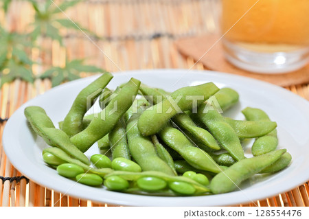 Delicious edamame beans on a plate and beer 128554476