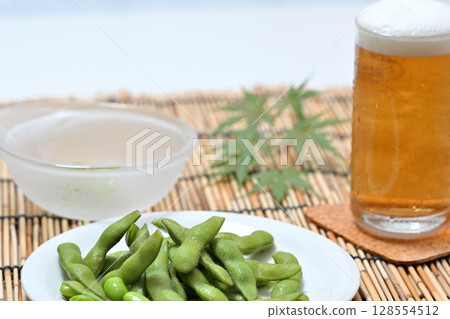 Delicious edamame beans on a plate and beer 128554512