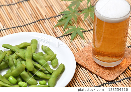 Delicious edamame beans on a plate and beer Delicious edamame beans on a plate and beer 128554516