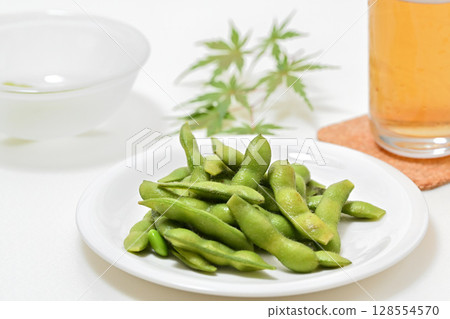 Delicious edamame beans on a plate and beer Delicious edamame beans on a plate and beer 128554570
