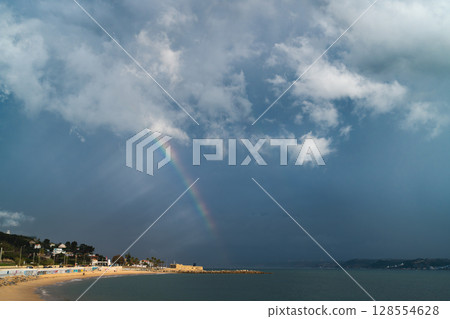 Rainbow Over Carcavelos Beach After a Rain Shower Rainbow Over Carcavelos Beach After a Rain Shower 128554628