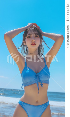 Woman in blue swimsuit on the beach Woman in blue swimsuit on the beach 128554818