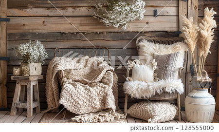 Inside the wooden room are a chair, blankets, pillows, and flowers 128555000