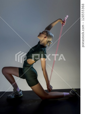 athletic girl holds rackets for bambinton athletic girl holds rackets for bambinton 128555368