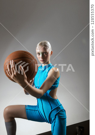 athletic girl holds rackets for bambinton 128555370