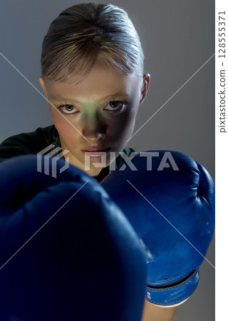 Sporty girl with boxing gloves 128555371
