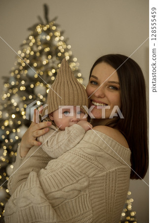 A woman holding a baby A woman holding a baby 128555459