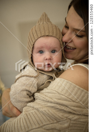 A woman holding a baby A woman holding a baby 128555460