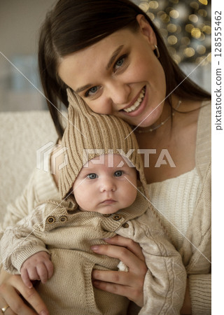 A woman holding a baby A woman holding a baby 128555462