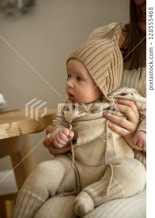 A woman holding a baby A woman holding a baby 128555468