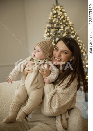 A woman holding a baby A woman holding a baby 128555480