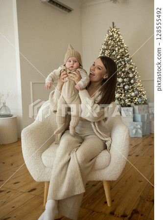 A woman holding a baby A woman holding a baby 128555492