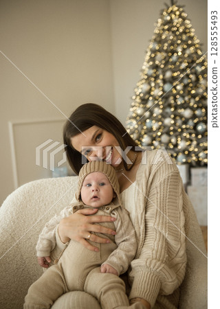 A woman holding a baby A woman holding a baby 128555493