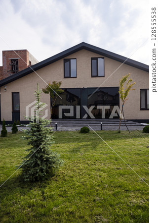 Courtyard of a private house. one-story house, lawn, playground. 128555538