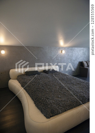 Bedroom with bed and window in the house. Bedroom with bed and window in the house. 128555569