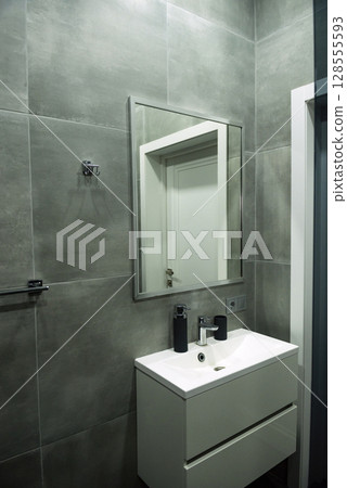 Bathroom with sink, cabinet and mirror. Bathroom with sink, cabinet and mirror. 128555593