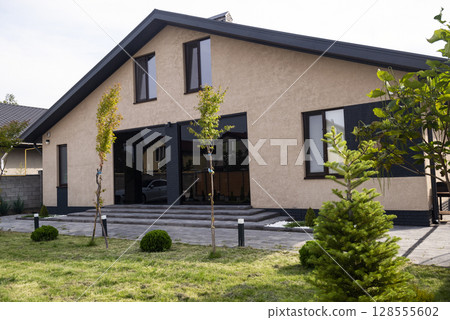 Courtyard of a private house. one-story house, lawn, playground. 128555602