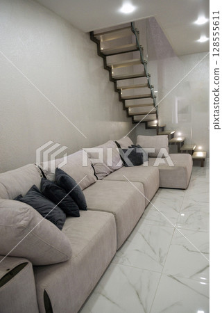 Living room. Light. There is a large sofa in the living room. Living room. Light. There is a large sofa in the living room. 128555611