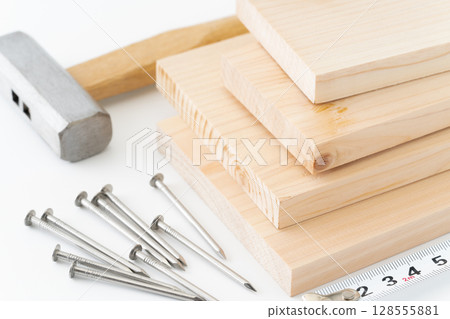 DIY image of nails, wood, hammer and tape measure on white background 128555881
