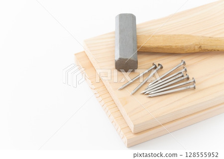 Nails, wood and hammer (carpentry tools) on white background 128555952