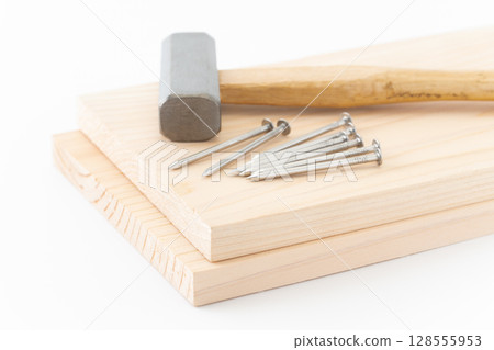 Nails, wood and hammer (carpentry tools) on white background 128555953