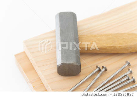Nails, wood and hammer (carpentry tools) on white background 128555955