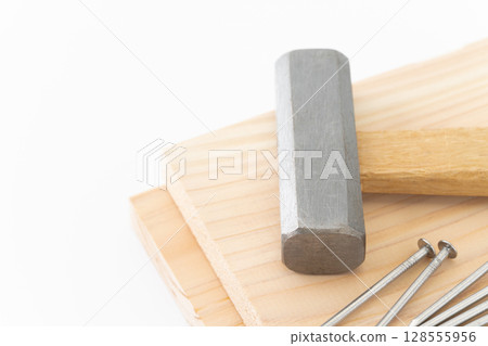 Nails, wood and hammer (carpentry tools) on white background 128555956