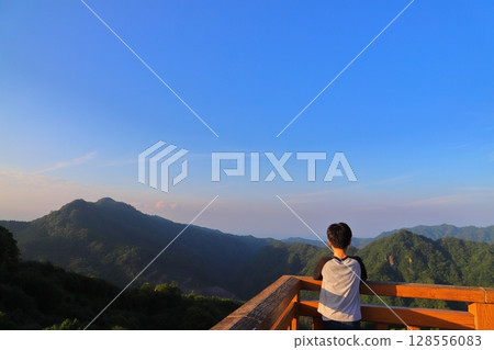 A boy looking out from the observation deck at Tsubakiyama Park 128556083