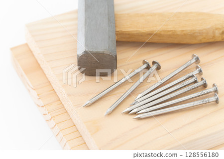 Close-up of nails, wood and hammer (carpentry tools) 128556180