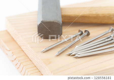Close-up of nails, wood and hammer (carpentry tools) 128556181