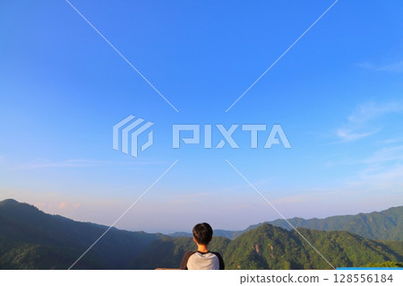 A boy looking out from the observation deck at Tsubakiyama Park 128556184