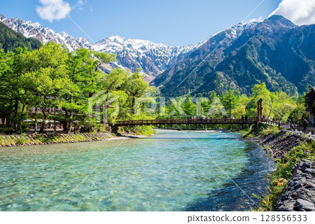 A spectacular view of Kamikochi: Kappa Bridge and the Hotaka mountain range in the season of fresh greenery A spectacular view of Kamikochi: Kappa Bridge and the Hotaka mountain range in the season of fresh greenery 128556533