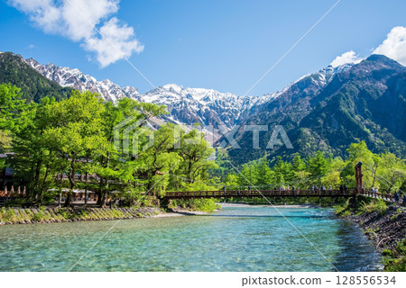 A spectacular view of Kamikochi: Kappa Bridge and the Hotaka mountain range in the season of fresh greenery 128556534