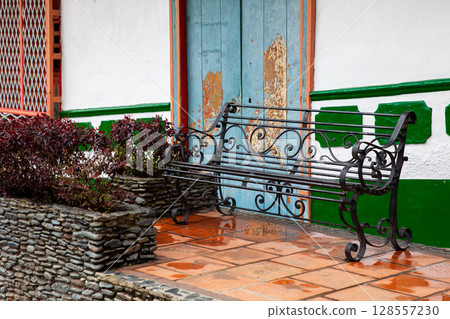 Metallic bench on one of the buildings around the Jose Maria Cordova Park in the beautiful colonial town of Concepcion in Antioquia, Colombia. 128557230