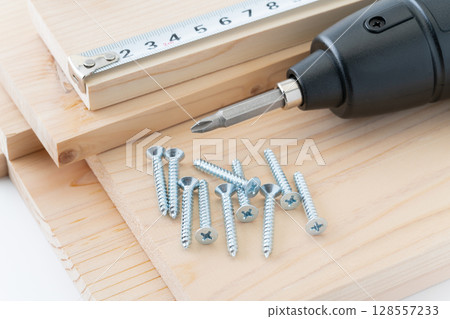 DIY image of tapping screws, wood, electric screwdriver and tape measure DIY image of tapping screws, wood, electric screwdriver and tape measure 128557233