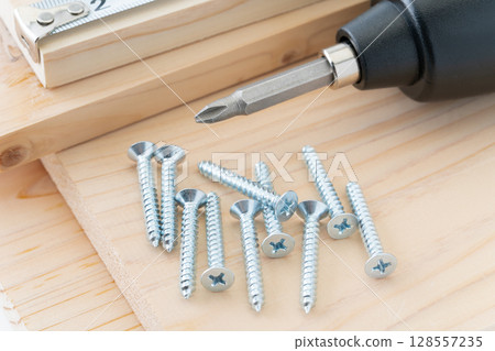 DIY image of tapping screws, wood, electric screwdriver and tape measure DIY image of tapping screws, wood, electric screwdriver and tape measure 128557235