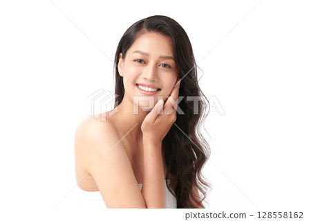 A beautiful young Asian woman with clean, fresh skin against a white background. Skincare, facial treatment, cosmetology, beauty, and spa. An elegant portrait of an Asian woman. A beautiful young Asian woman with clean, fresh skin against a white background. Skincare, facial treatment, cosmetology, beauty, and spa. An elegant portrait of an Asian woman. 128558162