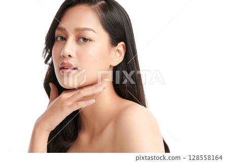 A beautiful young Asian woman with clean, fresh skin against a white background. Skincare, facial treatment, cosmetology, beauty, and spa. An elegant portrait of an Asian woman. 128558164