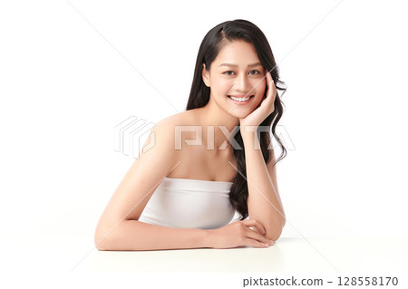 A beautiful young Asian woman with clean, fresh skin against a white background. Skincare, facial treatment, cosmetology, beauty, and spa. An elegant portrait of an Asian woman. 128558170