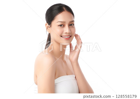 A beautiful young Asian woman with clean, fresh skin against a white background. Skincare, facial treatment, cosmetology, beauty, and spa. An elegant portrait of an Asian woman. 128558179