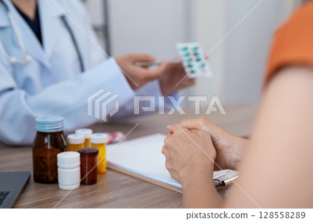 Doctor Consulting Patient and Prescribing Medication in a Medical Office Setting Doctor Consulting Patient and Prescribing Medication in a Medical Office Setting 128558289